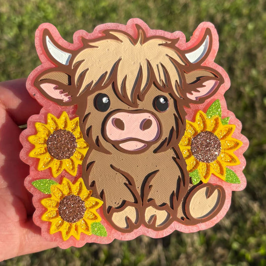 Highland cow with sunflowers